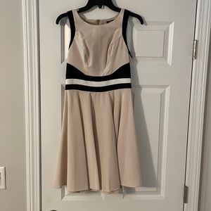 Beige dress with a black and white strip. Gold zipper on back.